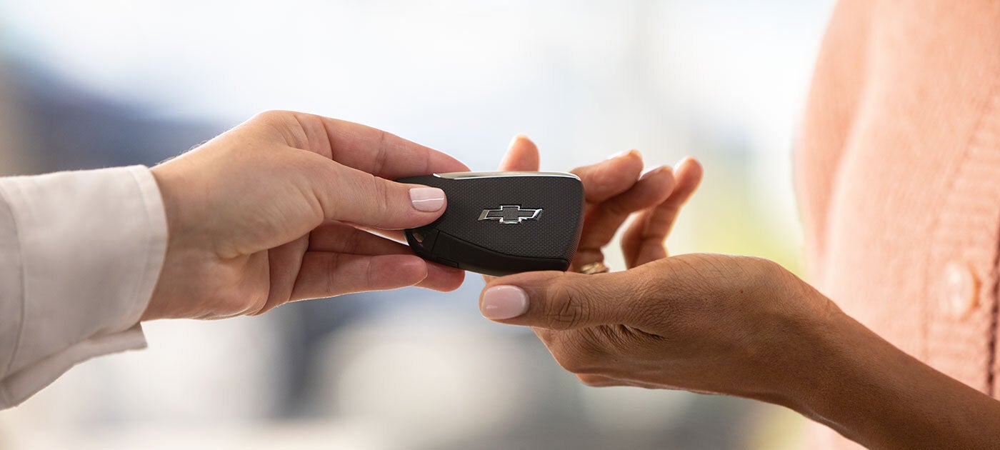 car salesman padding off keys to customers
